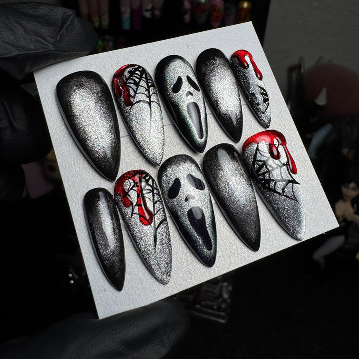 Silver cat-eye Ghostface press-on nails with spiderweb and blood designs