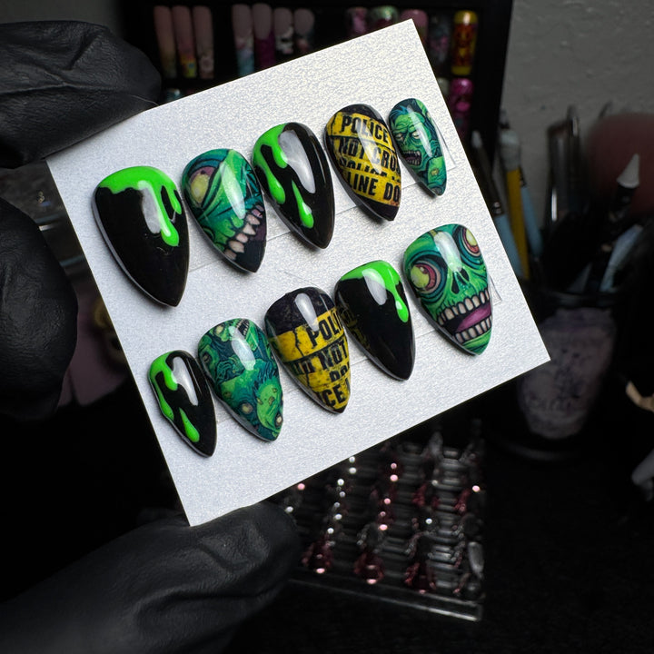 Toxic zombie press-on nails with crime-scene police-tape designs