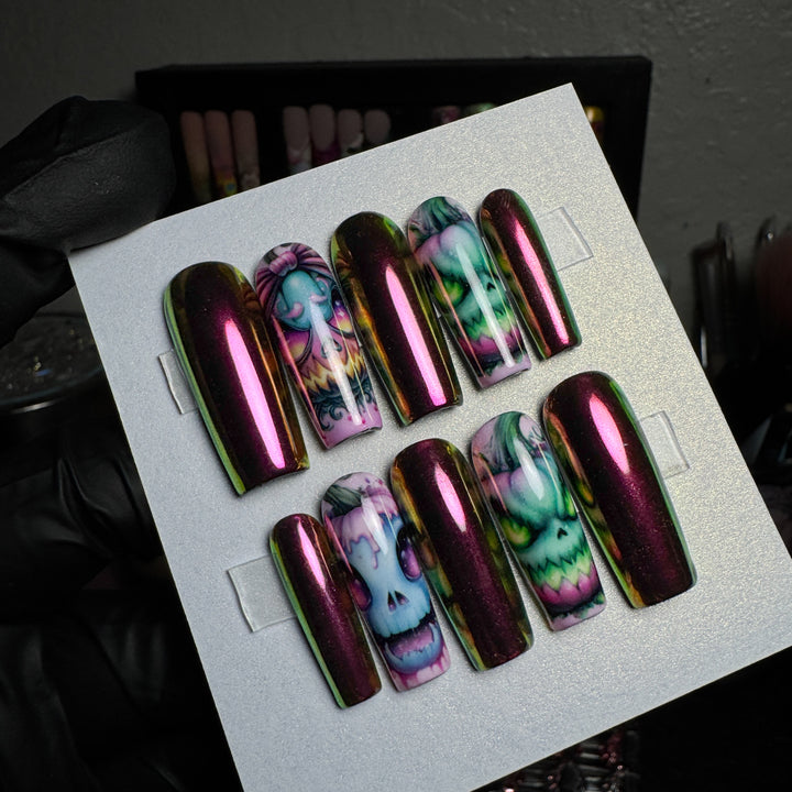 Burgundy chrome press-on nails with creepy carnival pumpkin designs