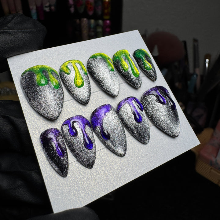 Neon green and purple press-on nails with dripping slime designs